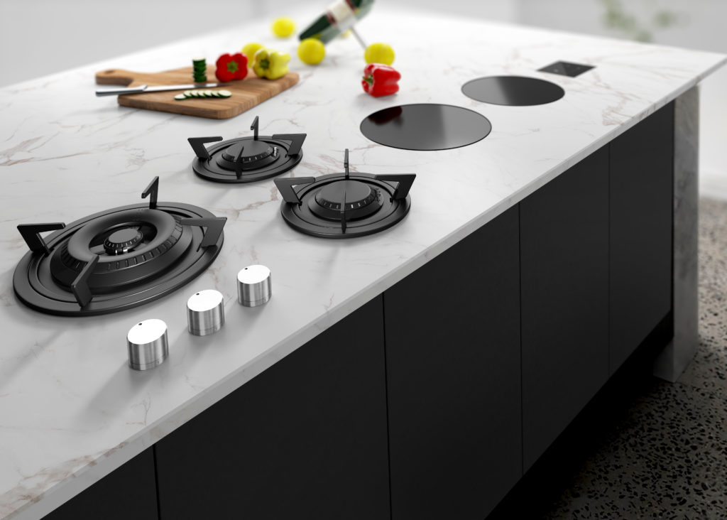 Three black burners and two induction burners on a white marble countertop